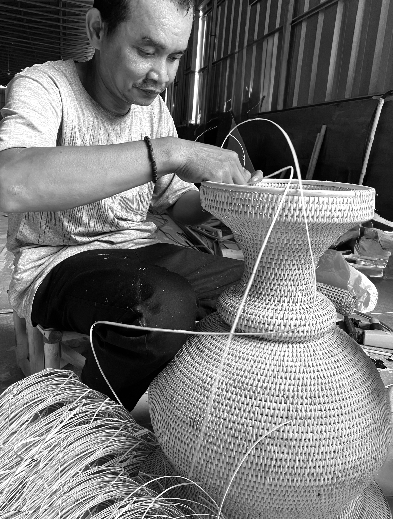 Indonesian craftsman weaving rattan by hand